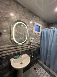 a bathroom with a sink and a mirror at Harmony Guest House in Ijevan +41 photos