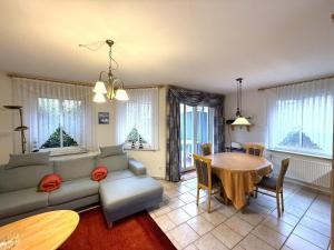 a living room with a couch and a table at Haus Meeresrauschen, Whg 1 in Duhnen
