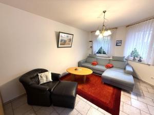a living room with a couch and a table at Haus Meeresrauschen, Whg 1 in Duhnen