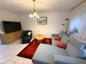 a living room with a couch and a table at Haus Meeresrauschen, Whg 1 in Duhnen +12 photos