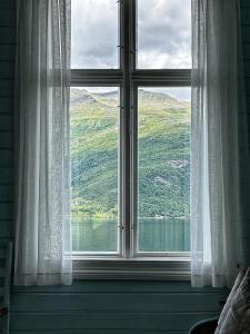 a window with a view of a mountain at Sommerhotellet in Vang I Valdres