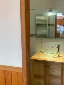 a bathroom with a glass sink on a counter at HOTEL & HOSTAL CHIL'IN, Las Trancas in Las Trancas +23 photos