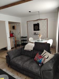 a living room with a couch and a table at Les Cactus in Grisolles