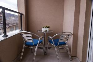 a small table and two chairs on a balcony at D&A Apartments in Novi Pazar