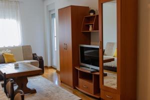 a living room with a couch and a tv in a cabinet at D&A Apartments in Novi Pazar