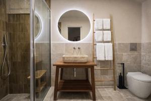 a bathroom with a sink and a mirror at CAVA Urban Relais & Pool in Lecce +53 photos