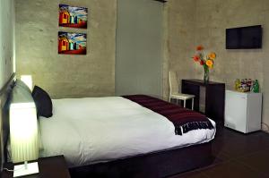 Ліжко або ліжка в номері Hoteles Riviera Mansion