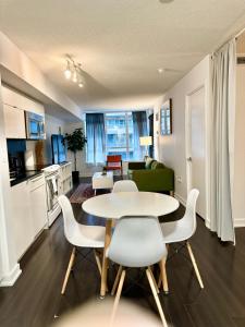 a kitchen and living room with a table and chairs at Cozy Condo near CN Tower in Toronto