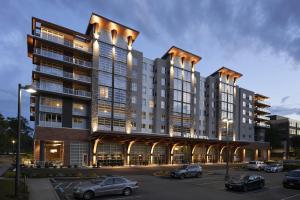 a rendering of a building with cars parked in a parking lot at Archer Hotel Seattle/Redmond in Redmond