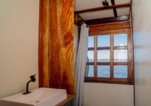 a bathroom with a sink and a window at Yara Floating Villa in Guriú +4 photos