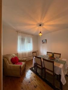 a living room with a table and a couch at Apartman Demirovic in Orašac +39 photos