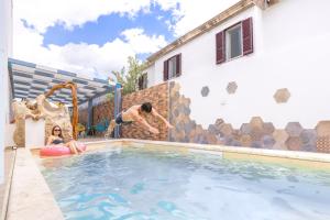 a man is playing in a swimming pool at Agua Dorada Retreat in Lula