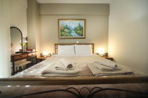 a bedroom with a bed with towels on it at The Bliss Z1 in Kastoria