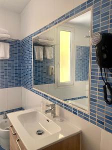 a bathroom with a sink and a mirror and a toilet at Hotel Paris Centro in Zaragoza +35 photos