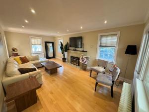 a living room with a couch and a fireplace at Spacious 4-Bedrooms Friendly House-Pool-Parking in Markham