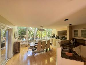 a kitchen and living room with a table and chairs at Spacious 4-Bedrooms Friendly House-Pool-Parking in Markham