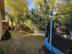 a swing in the yard of a house at Spacious 4-Bedrooms Friendly House-Pool-Parking in Markham