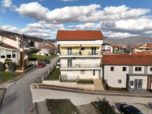 a white house with a red roof on a street at The Bliss Z1 in Kastoria
