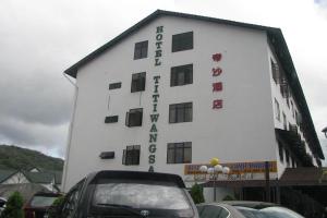 a white building with writing on the side of it at Hotel Titiwangsa in Brinchang
