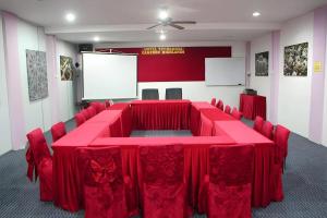 a conference room with a red table and chairs at Hotel Titiwangsa in Brinchang
