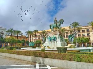 a statue of a man on a horse in front of a building at Penthouse Arenal - Boutique Puerta Real in Jerez de la Frontera