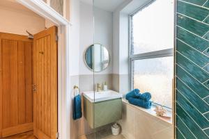 a bathroom with a sink and a mirror at Spacious 2-Bed Flat with Panoramic Views in Portsmouth +18 photos