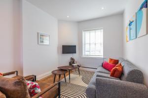 a living room with a couch and a table at Spacious 2-Bed Flat with Panoramic Views in Portsmouth
