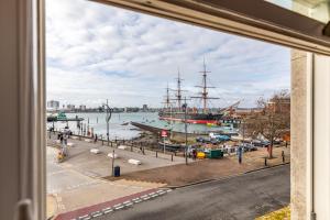 a large ship is docked at a marina at Spacious 2-Bed Flat with Panoramic Views in Portsmouth