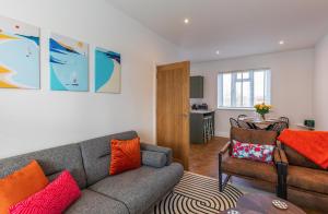 a living room with a couch and a table at Spacious 2-Bed Flat with Panoramic Views in Portsmouth