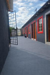 an open door to a building with red doors at 6 Tiger guest house in Katlehong