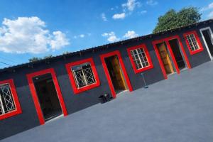 a blue building with red doors and windows at 6 Tiger guest house in Katlehong