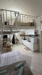 a living room with two bunk beds and a kitchen at Casa Della Felicità in Naples