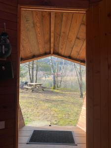 an open door in a cabin with a view of a park at domaine des planesses in Ferdrupt