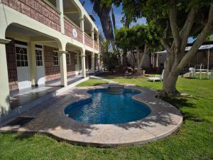 a small pool in a yard next to a building at Hotel de la Cruz in Maguey Blanco