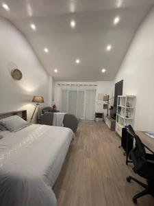 a bedroom with a bed and a desk in a room at Un cocoon spacieux in Les Essarts-le-Roi