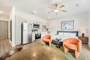 a bedroom with a bed and two chairs and a table at King Studio Getaway! Prime Location, Balcony, Gym - S2 in Atlanta