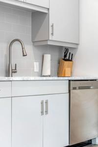 a kitchen with white cabinets and a sink at King Studio Getaway! Prime Location, Balcony, Gym - S2 in Atlanta +22 photos