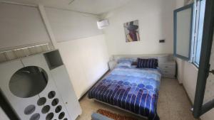 a small bedroom with a bed and a window at Z House Jbeil in Jbeil