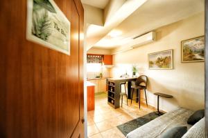 a kitchen and living room with a table and chairs at The Bliss Z1 in Kastoria +30 photos