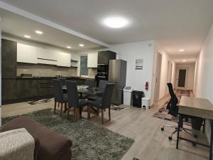 a living room and kitchen with a table and chairs at Modern 3-Bedroom Apartment - Ideal for Families and Business - Near Airport in Luqa