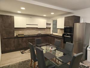 a kitchen with a dining table and a refrigerator at Modern 3-Bedroom Apartment - Ideal for Families and Business - Near Airport in Luqa +8 photos