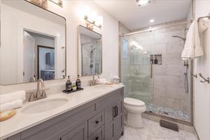 a white bathroom with a sink and a shower at Dollar Point - Observation Dr, home in Tahoe City