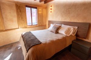 a bedroom with a large bed and a window at Hotel Casa de las Abuelas in Guanajuato