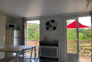 a kitchen with a table and a table and a window at domaine des planesses in Ferdrupt