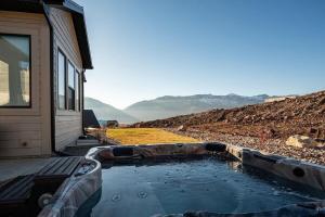 a pool of water next to a house at Powder Mtn Chalet B4 Ski Escape Hot Tub & View in Eden