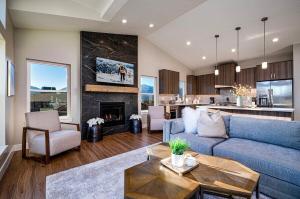 a living room with a blue couch and a fireplace at Powder Mtn Chalet B4 Ski Escape Hot Tub & View in Eden