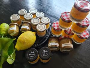 a group of jars of honey and a plate of lemons at Le Citrus - Séjour cosy en plein centre historique in Montaigu-Vendée