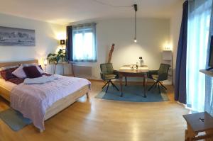 a bedroom with a bed and a table and chairs at Frisch renoviertes BergSeeNest in Bad Bayersoien