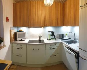 a kitchen with a sink and a microwave at Frisch renoviertes BergSeeNest in Bad Bayersoien
