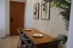 a dining room table with two chairs and wine glasses at Design e Amor no Centro in Palmas +26 photos